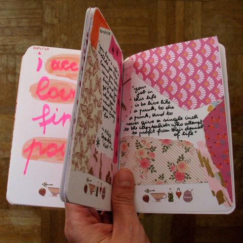 Artjournal that is held open so pages with collages and hand-written quotes are visible. One quote says: "Your job in this life is to live like a punk, to die a punk, and to never give a single inch to the capitalists who attempt to profit from their denial of life." The quote is from Alice Sparkly Kat's instagram.