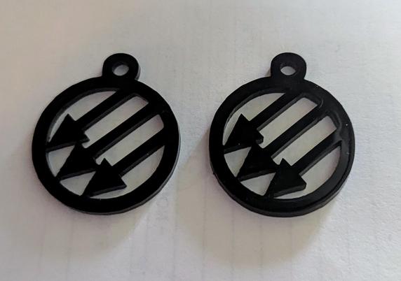 A pair of black acrylic earrings laser cut in the anti fascist logo.