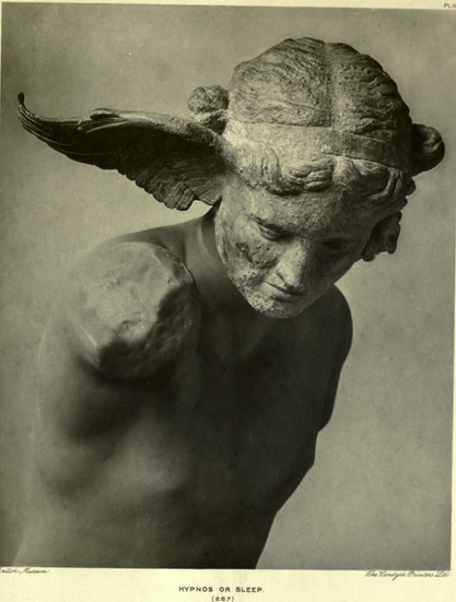 A black and white photograph of an sculpture with the text "Hypnos or Sleep" below. The sculpture is a torso of a young male figure with a downward gaze. The right side of head features a large, wing-like projection. Both arms of the sculpture are broken off, and the surface shows weathering and erosion. The caption at the bottom reads “Hypnos or Sleep (867)."