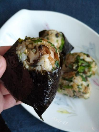 One riceball handheld closer to camera.