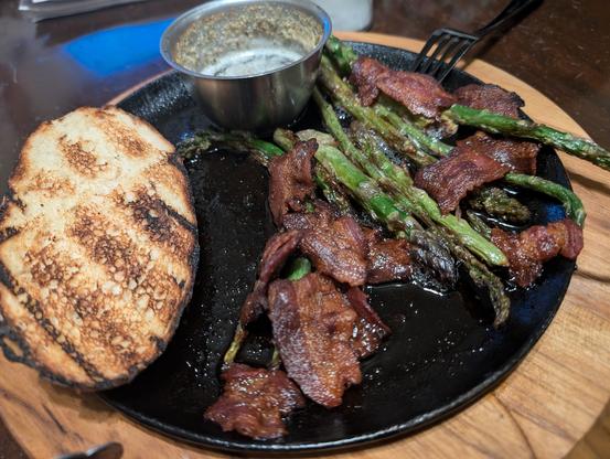 Bread, bacon, and asparagus, all slow smoked on the new grill. There's some garlic and chive butter that got smoked too available for dipping. It's still sizzling on the cast iron plate I grilled it on. Nom on mighty warrior.