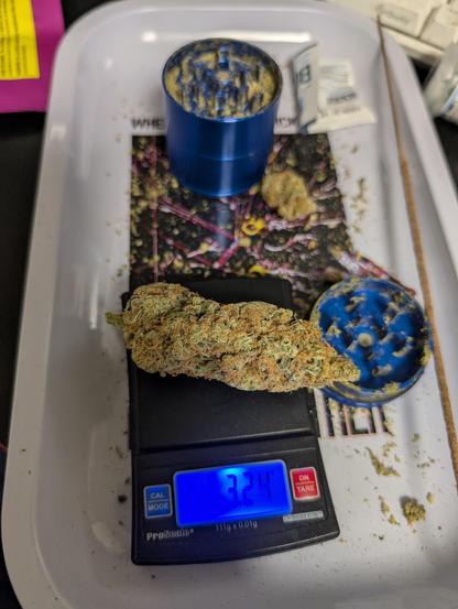 the same nug on a digital scale. the scale reads 3.24g.