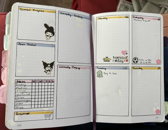 A planner spread with 6 boxes on one page and four boxes on the other. The first page has current projects, area radar, a habits table, groceries, currently reading, and currently playing with a black and white my melody in current projects and a black and white Kuromi in area radar. The opposing page has a box for Monday 26 to Thursday 29 with a sticker for Memorial Day and no school on Monday 26 along with a pink heart around a blue heart. The Tuesday box has a dinosaur that says boy to bus. Wednesday and Thursday have a Sakura flower. Wednesday also has a soccer ball and Austin vs RSL @ 6:30 PM. The pages have touches of pink, blue, and yellow to decorate.