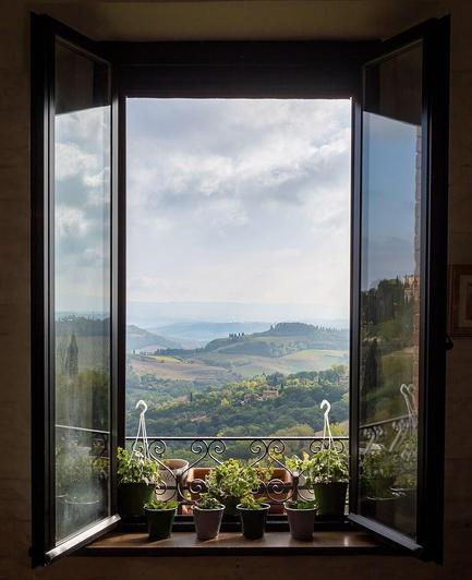 The window in a cafe in San Gimignano opens on Valdelsa, in Tuscany (Italy).