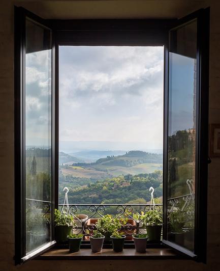 The window in a cafe in San Gimignano opens on Valdelsa, in Tuscany (Italy).