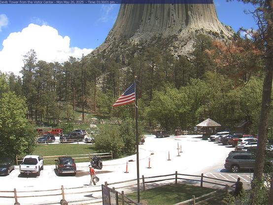 This webcam updates every 30 seconds to show a still image of live conditions at the park. The webcam is mounted on the historic Devils Tower Visitor Center. Parking is limited with peak visitation in the summer between 10 AM and 3 PM with both the visitor center and lower dirt parking lots filling completely. The visitor center flagpole is in the middle of the image.