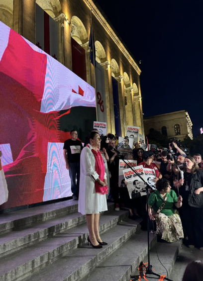 President Salome Zourabishvilli on the steps of parliament in Tbilisi, Georgia addressing a huge crowd of protestors.
