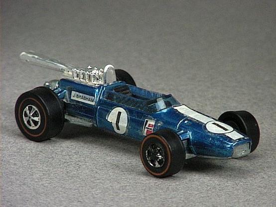 Released in 1969, Spectraflame Olive Brabham Repco FI of 1969 Grand Prix with Redline wheels. Notes: Based on Formula 1 racer car designed by John Cooper. Car has exposed chrome colored plastic rear engine and chrome colored plastic tail pipe. Some models have detachable fuel tanks. Packaging: Grand Prix. Metal Body, Metal Base. Made in Hong Kong. Scarcity: 4/10