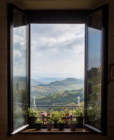 The window in a cafe in San Gimignano opens on Valdelsa, in Tuscany (Italy).