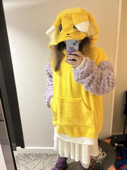 Mirror selfie of Light (person) wearing an oversized Reanamon hoodie in a hotel room.