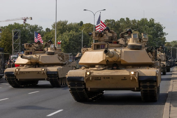 A photograph of US Army Abrams tanks participating in a military parade in Warsaw in 2024. The show of force planned in Washington for the Donald Trump's birthday on June 14 is supposed to include 28 such tanks.