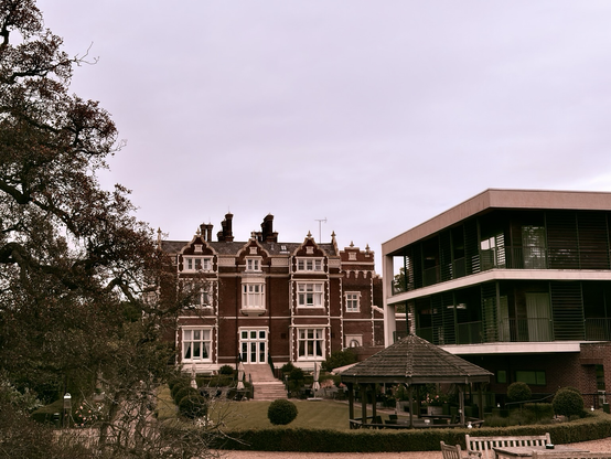 An antique hotel on a grass.