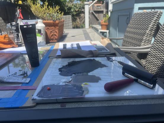 My white plastic ink slab used as a paint palette for acrylics. A brayer is roller up, having been used to create the dark brown for image transfer