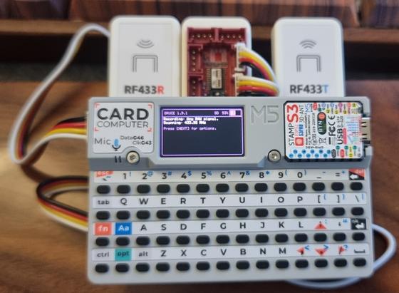 A cardputer unit with 433mhz receiver and transmitter units attached with wire