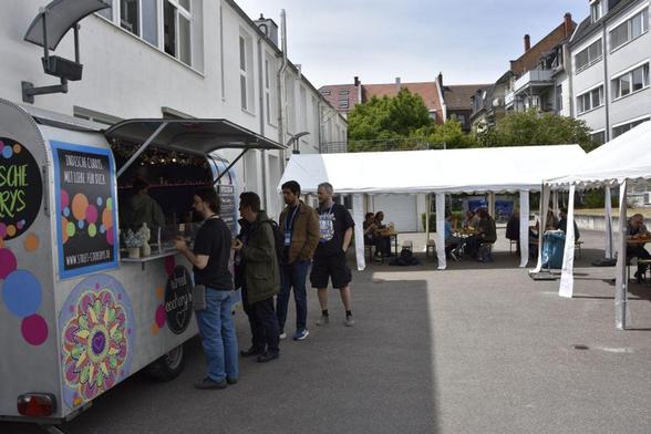The GodotCamp outdoors, a food truck providing delicious vegan meals on the left