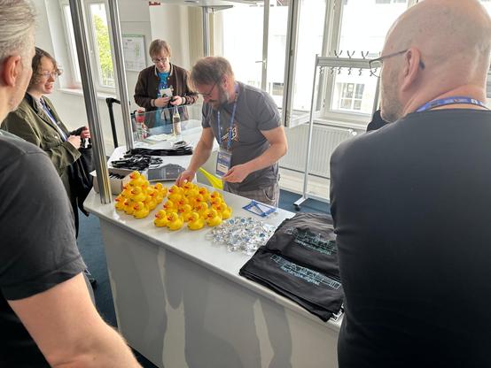 The sponsor merch booth with rubber ducks, shirts, pins, pens and more