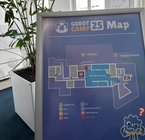 Our map of the venue with a confused stylized godot plushy in the bottom right corner