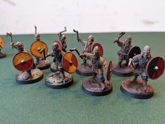 A group of miniature vikings with axes and shields.