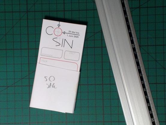 Stack of cut out CoSin entrance badges ready to be distributed.