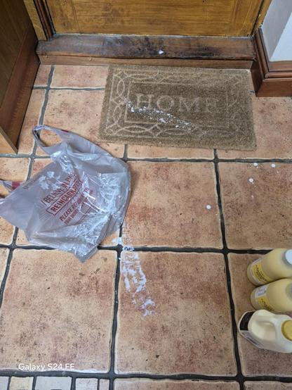 Cream all over the doormat and floor.