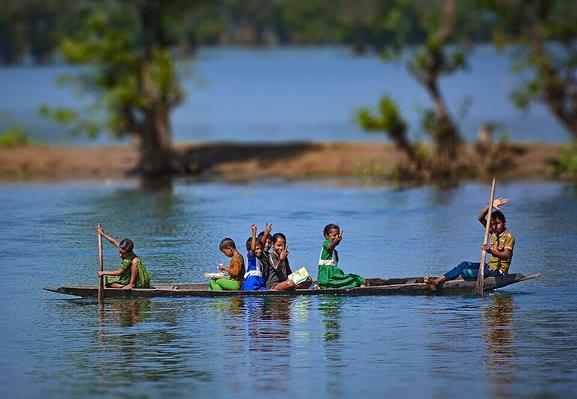 Children in a boat on the Shari-Goyain River in Ratargul Swamp Forest, Bangladesh. Today is also Bengali new year.