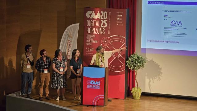 Présentation du CAA-FR au colloque du CAA international. 5 personnes présentent debout en regardant vers le support