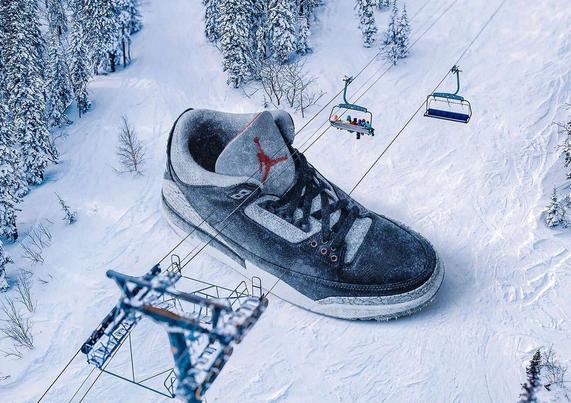A giant sneaker rests on a snowy slope, with ski lifts carrying passengers above in a winter landscape.