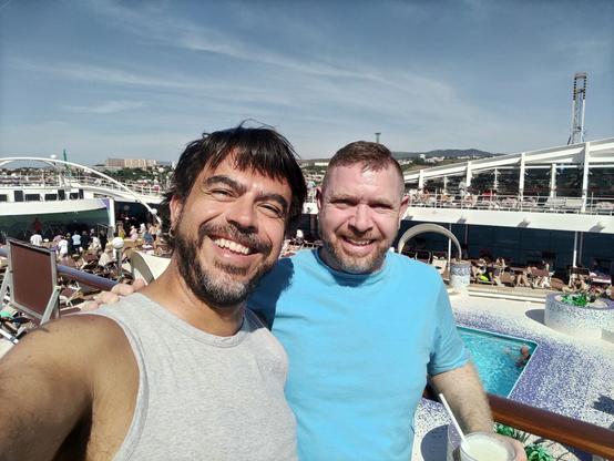 Selfie with my husband on the boat before leaving Marseille. I'm wearing a grey sleeveless t-shirt and his is light blue.