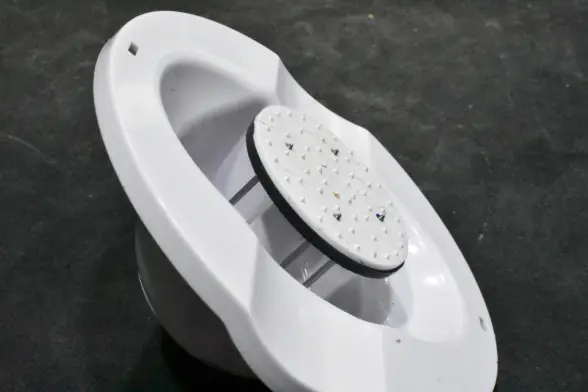 A white plastic food pusher from an OXO Good Grips mandoline, modified with an ABS reinforcing plate behind the thin plastic pusher plate