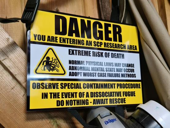 An SCP themed sign, warning of changeable physical laws and abnormal mental states.