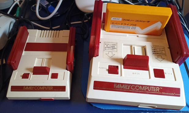 A Famicom next to a Famicom Mini.