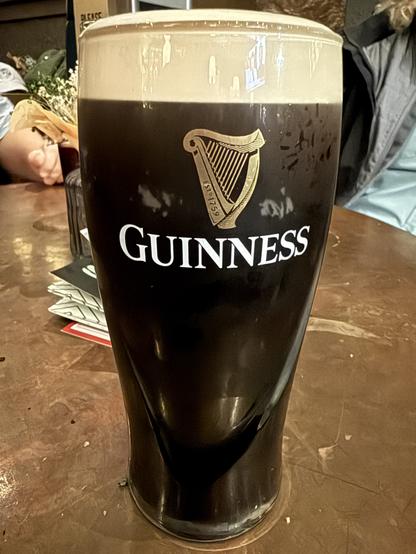 A proper pint of Guinness with a rich tan head