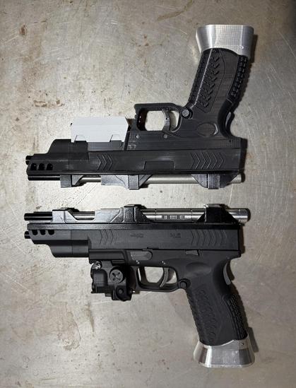 Two replica (prop) MCRN pistol variations. The bottom one is based off an Airsoft as they were on the show, with a CNC'd upper barrel assembly, etc. The upper one is mostly 3D-printed with metal barrel components... The slide, trigger, mag, grip safety, etc. all function on the lower one, but not the printed one.
