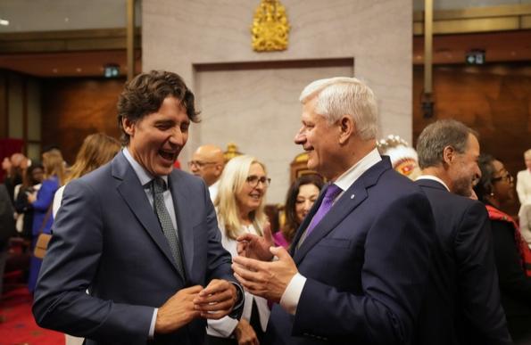 Photo of former Prime Ministers Stephen Harper (Conservative) and Justin Trudeau (Liberal) having a big jolly laugh together during the royal visit.