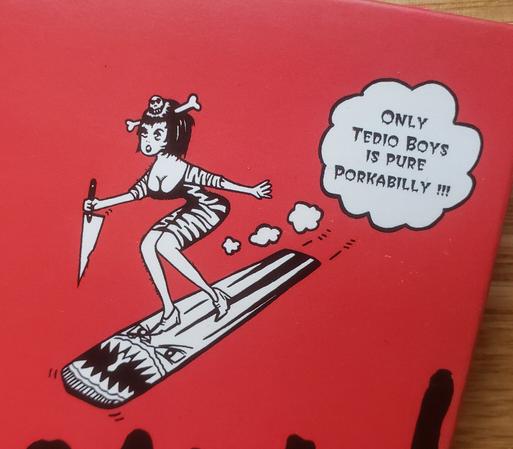 A woman in an animal print dress with a bone in her hair carries a giant knife while surfing through air on a tiki board.