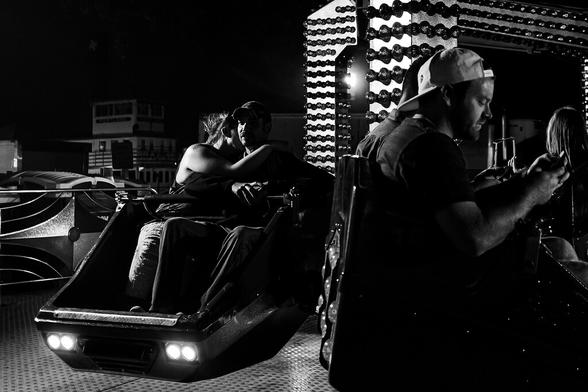 Favorite from a Rose Festival past - Monochrome photo of a woman resting her head on a man's shoulder. They're on a Tilt-a-Whirl