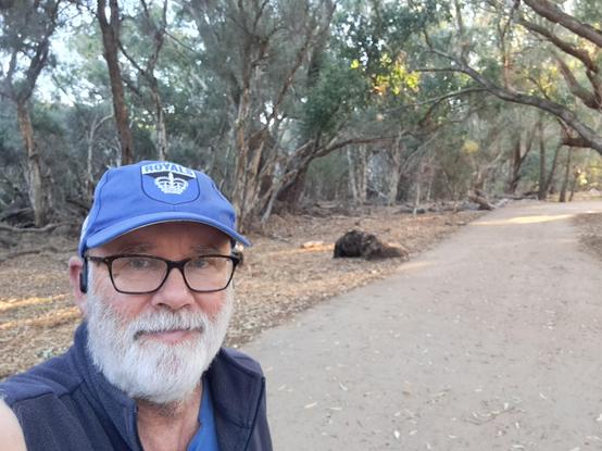 Selfie on path in Carine Open Space flanked by trees and bush.