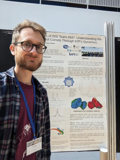Selfie In front of a science filled poster.