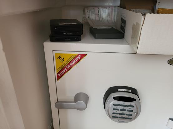 A pile of 2.5" hard drives on top of a safe