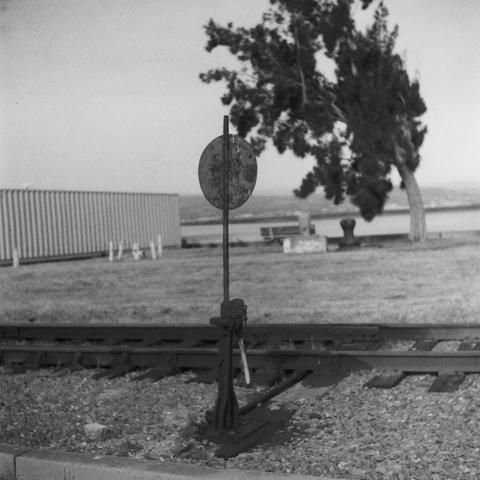 a railroad switchstand is in the foreground, in focus, there are trees in the background slightly out of focus (on purpose, I swear)