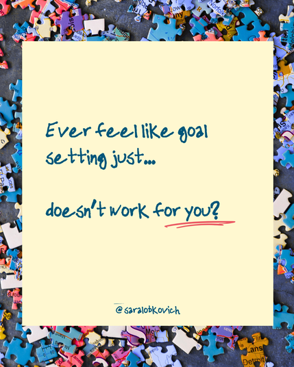 In the background is blue, soft red, and yellow puzzle pieces, all messy. In the foreground, on a yellow block that looks like a sticky note is the copy:

Ever feel like goal setting just...

doesn’t work for you?