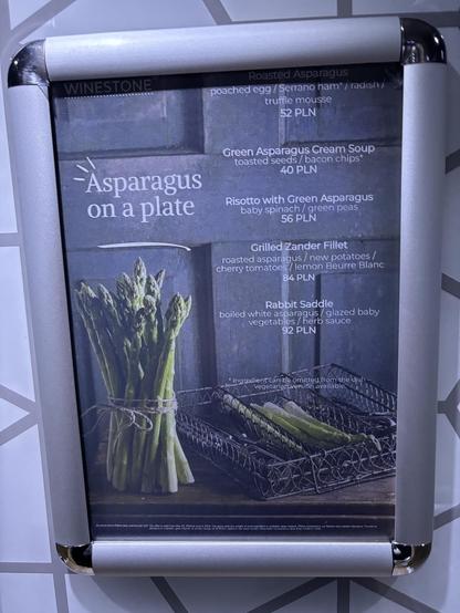 Noticed within a hotel lift, describing the hotel's seasonal asparagus dishes.