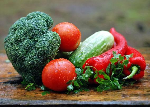 table with fresh red and green vegetables on it