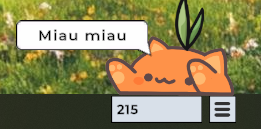 Captura de Bongo Cat en mi escritorio, que es un jueguito de productividad de Steam, para contar clics y canjearlos por skins al azar. 

El mío ahora es naranja con un retoño de césped en la cabeza. tiene un globito de texto que dice "Miau miau".