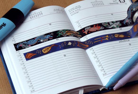 photo of a journal showing off washi tape with japanese tattoos and medieval instruments