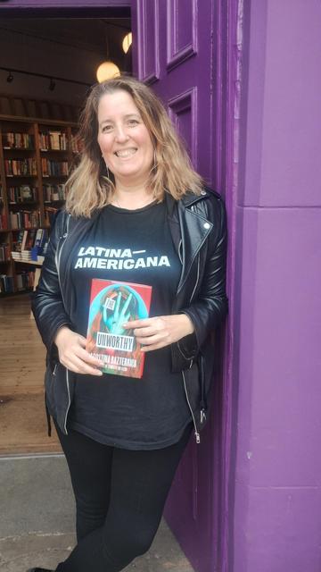 Argentinian author Agustina Bazterrica smiling in the doorway of the Edinburgh Bookshop