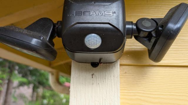 picture of a mr. breams wireless spotlight attached the front cornr of my house