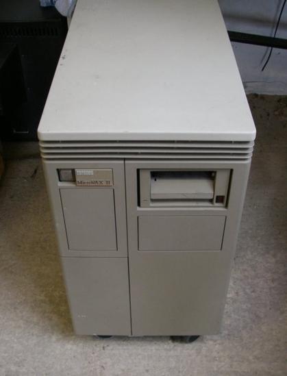 A DEC MicroVax 2 with a built in TZ30 tape drive sitting alone on a concrete floor.