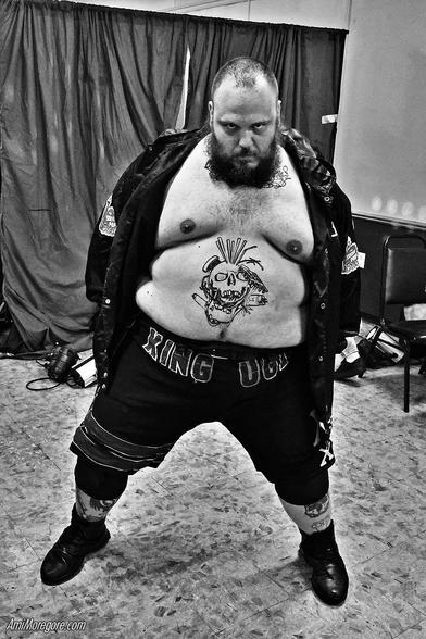 Jeff Cannonball makes his entrance
he is a large man bearded man wearing a jacket but no shirt showing a tattoo on his belly of a skull with various deathmatch implements stuck in his head. Across his shorts is written "King Ugly"
