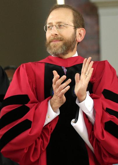 Alan Garber, President of Harvard, in a snazzy red ball gown.